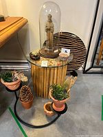 Full view including monk cloche on glass-topped limb table, surrounding props not included