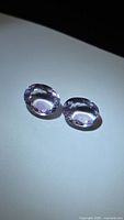 Top view of both oval amethysts showing color and faceting