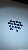 Group of square cut blue sapphires on white background