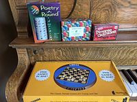 All four boxed games displayed on piano