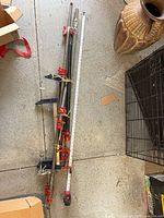 All six pipe clamps laid out beside tape measure showing length