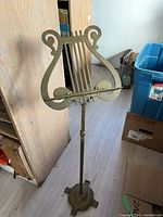 Full view of brass adjustable music stand