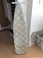 Front view of full-size ironing board with cover