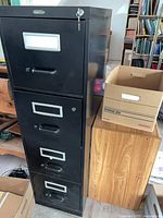 Front view of black 4-drawer metal filing cabinet