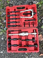 Tool set opened showing slide hammer, yoke and various collets in case