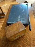 Paper cutter base and wooden recipe box on table