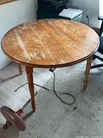 Full view of table showing size, turned legs, wear on top