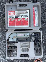 Profile sander kit showing tool, cord and profile pads in case