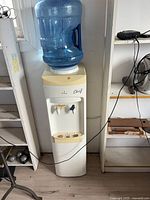Full view of water cooler with bottle attached