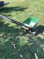 Side view of Scotts Basic broadcast spreader showing hopper and handle