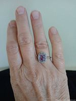 Ring worn on hand showing size and style