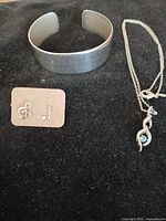Full view of cuff bracelet, earrings on card, necklace