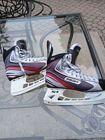 Pair of Bauer Vapor X3 skates side view on glass table