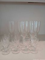Full set of champagne flutes and liquor glasses grouped together