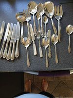 All utensils laid out showing knives row and assorted serving pieces