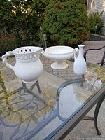 All three white ceramic pieces on glass table outdoors