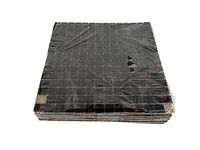 Stack of shrink-wrapped glass mosaic tile sheets