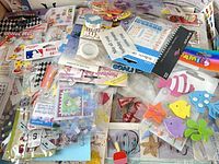 Top view of assorted sticker sheets, foam shapes and embellishment packs spread out