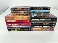Two stacks of Anne McCaffrey hardcovers showing spines with titles
