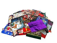 Pile of assorted Christmas gift bags, various sizes and designs visible