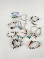 Group of nine bracelets, one necklace, packaged loose beads