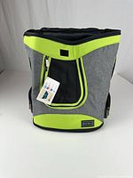 Front view of Petsfit backpack displaying mesh panel, zippered opening, attached hang tag