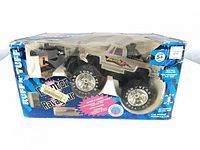 Front view of boxed Ruff N' Tuff Eruptor Ravageur RC monster truck and controller visible through damaged plastic window