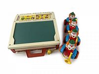 Fisher-Price desk and Blue-Box clown pull toy side by side