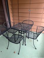 Table with four chairs on patio showing overall set layout