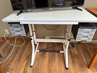 Front view showing adjustable legs, footrest bar, and twin drawer units