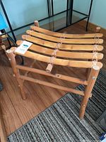 Oblique view of bamboo slatted stool showing frame and seat