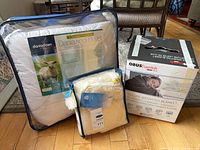 All three packaged items: DaniaDown duvet, wool pillow cover, ObusEssentials weighted blanket box