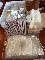 Lot overview showing plastic cube boxes, basket bags and condiment cups