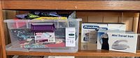 Shelf view showing fabric bin, Proctor Silex iron box, Mini Travel Iron box