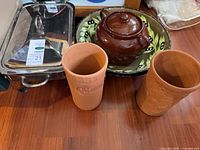 Group shot: Marinex dish with stand and lid, bean pot, serving bowl, two terra cotta wine coolers