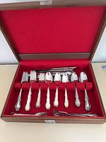 Open chest showing arranged spoons, forks and knives