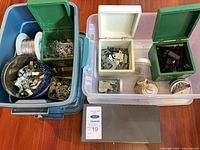 Overview of totes containing assorted frame hardware and supplies