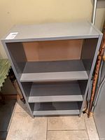 Front view of grey 3-tier shelf unit
