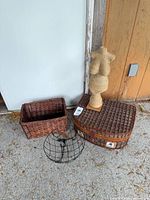 Group shot of wicker picnic hamper, rectangular wicker basket, wire basket and rope-wrapped torso sculpture