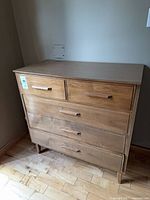 Front view of dresser showing drawer layout and handles