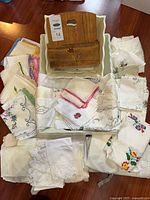 Group of assorted linens, wooden box and tray