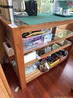 Full view of wood frame shelving with glass shelves, contents not included