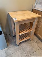 Front angled view showing full cart, top, shelves, wheels