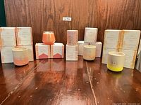 Front view of all boxed candles with several unboxed vessels