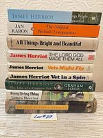 Nine books stacked showing spines