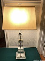 Full lamp showing shade, stacked glass body, chrome base