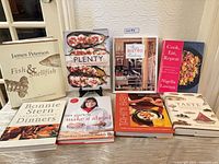 All eight cookbooks displayed upright and flat