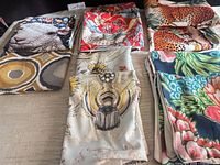 Overview of six different cushion covers folded on table