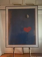 Full view of framed print on easel