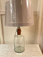 Full lamp with shade displayed on surface